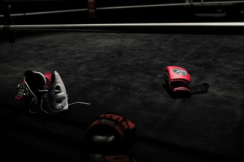 red boxing gloves and helmet on floor