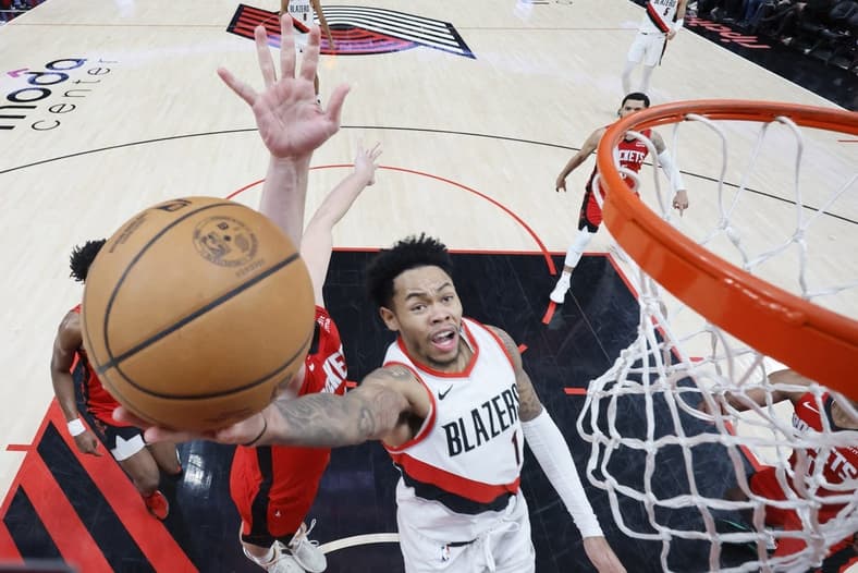 Mar 8, 2024; Portland, Oregon, USA; Portland Trail Blazers shooting guard Anfernee Simons (1) shoots the ball past Houston Rockets center Alperen Sengun (28) during the second half at Moda Center. Mandatory Credit: Soobum Im-USA TODAY Sports