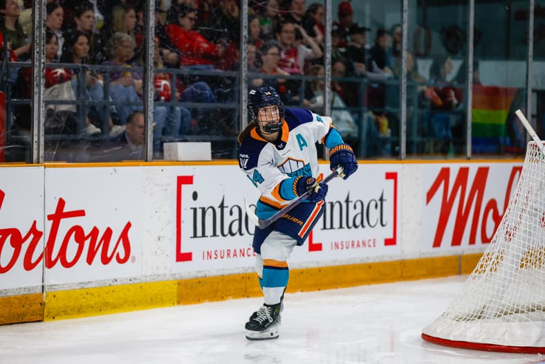 New York Sirens alternate captain Jaime Bournonnais carries the puck behind her own net.