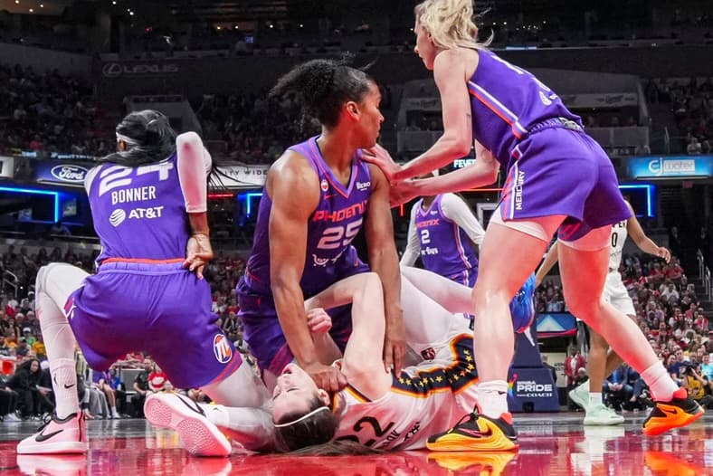 Phoenix Mercury forward Alyssa Thomas (25) scrambles to get up over Indiana Fever guard Caitlin Clark (22) on Wednesday, June