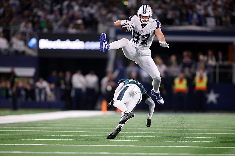 Dec 10, 2023; Arlington, Texas, USA; Dallas Cowboys tight end Jake Ferguson (87) jumps over Philadelphia Eagles cornerback K…