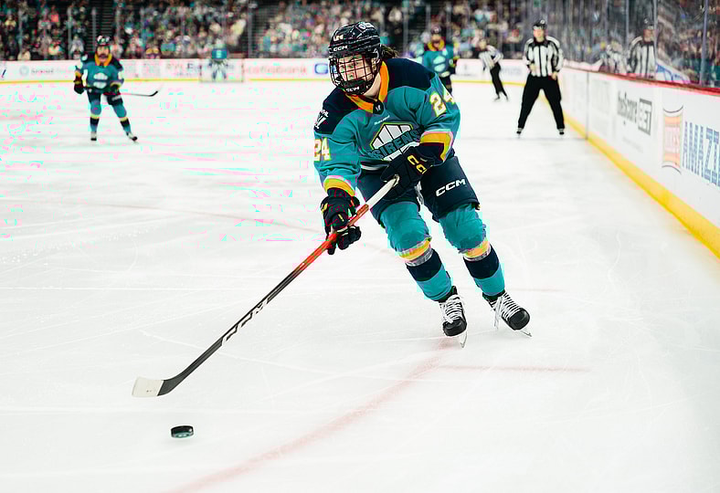 New York Sirens rookie Anne Cherkowski digs out the puck against the Minnesota Frost.