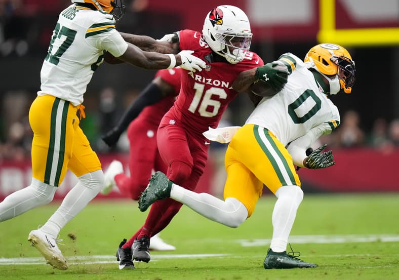 Arizona Cardinals cornerback Max Melton (16) breaks away from a block by Green Bay Packers receiver Romeo Doubs (87) to tackle