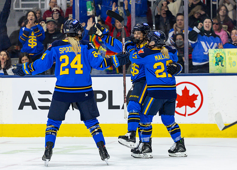 Toronto Sceptres forward Maggie Connors celebrates with teammates Natalie Spooner and Emma Maltais after scoring a game-opening goal against the Montreal Victoire.