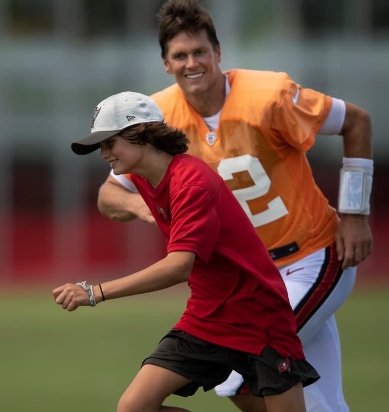 Tampa Bay Buccaneers quarterback Tom Brady (12) chases his son Jack across the field after a joint training camp practice